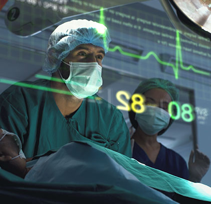A surgeon during CABG surgery monitoring ECG and other vitals